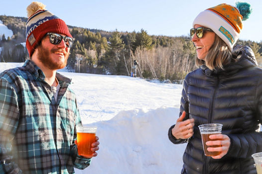 Woman and Man Drink Beer Apres Ski at Attitash