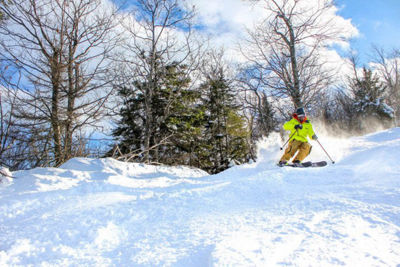 Skier Turns Through Fresh Snow at Attitash
