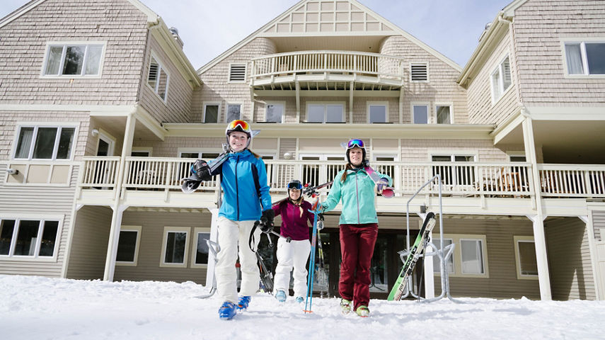 Group of Skiers Walks in Base Area at Attitash
