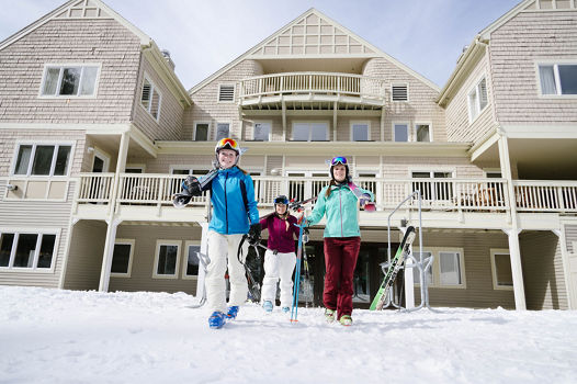 Group of Skiers Walks in Base Area at Attitash