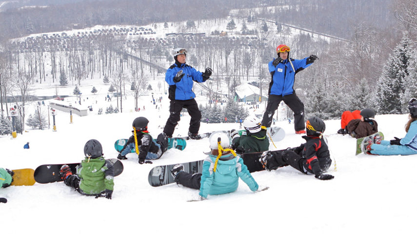 Snowboard Instructors Give Group Lesson on Fanny Hill at Roundtop