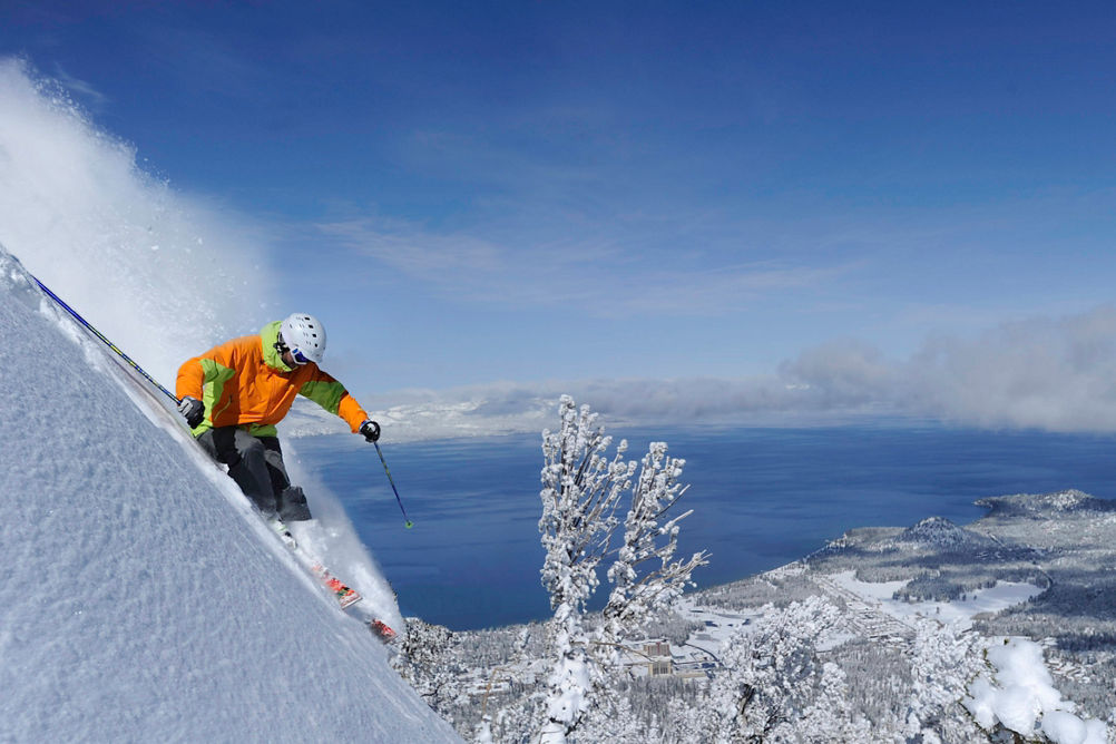 Skier in fresh powder overlooking Lake Tahoe in Heavenly, CA.
