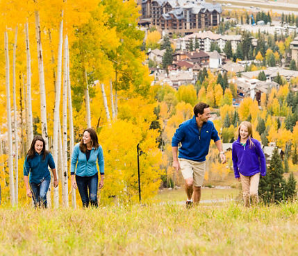 Family goes hiking In Vail, CO during a fall day