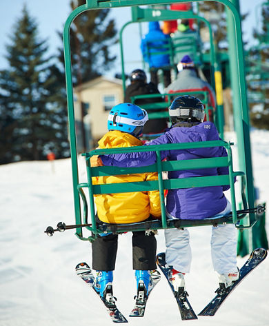 Skiing Family Riding Chairlift In Afton Alps, MN