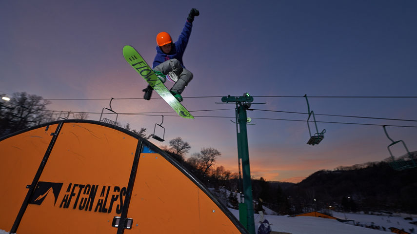 Snowboarder On Rainbow Rail In LZ Terrain Park In Afton Alps, MN
