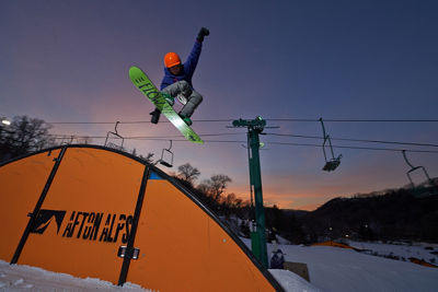 Snowboarder On Rainbow Rail In LZ Terrain Park In Afton Alps, MN