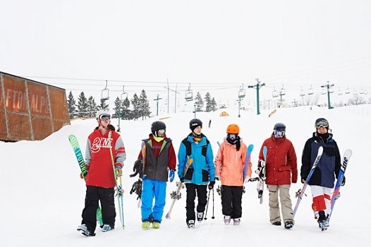 Teens Walking With Gear In LZ Terrain Park In Afton Alps, MN.