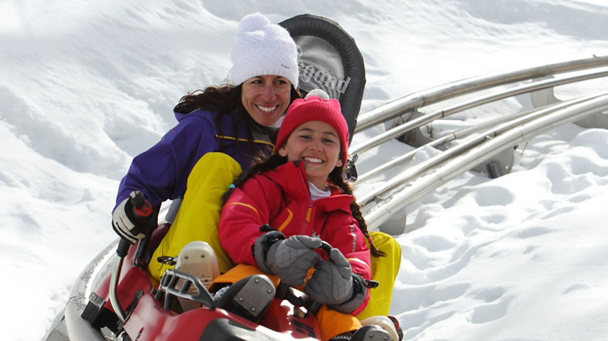 Mom and daughter ride on the Alpine Coaster in Park City Mountain Resort, UT.