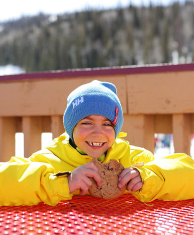 Family Takes a Break Mid-Mountain while Skiing in Park City Mountain Resort, UT.