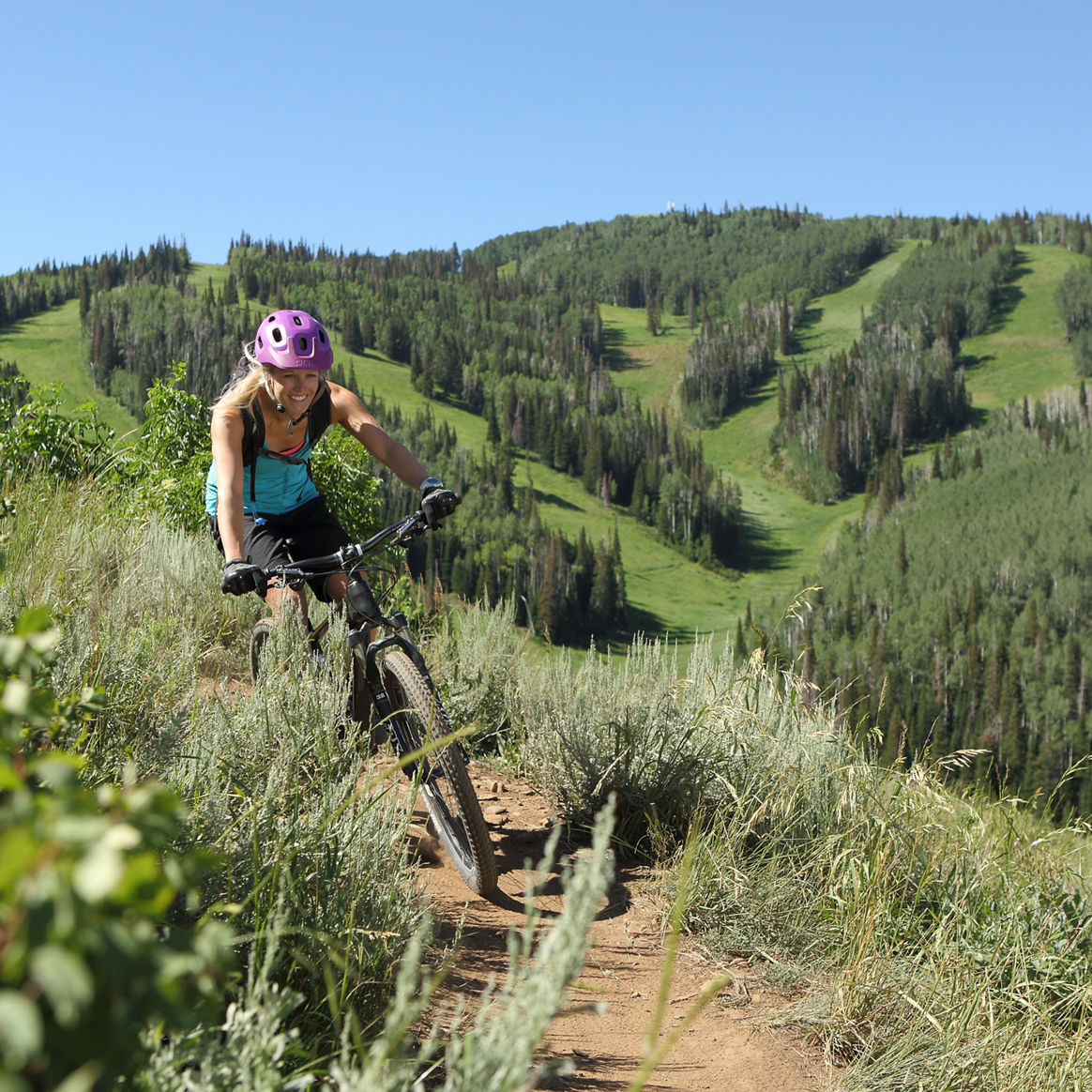 Woman Biking on Mountain in Park City Mountain Resort, UT.