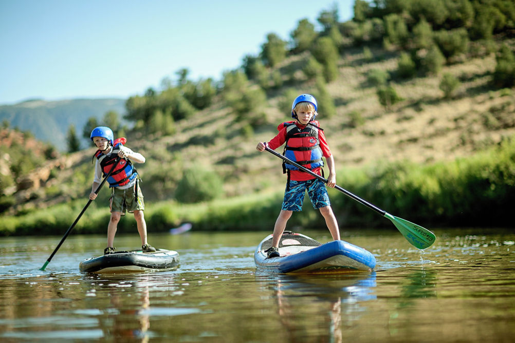 Stand Up Paddleboarding at Kids Camp in Beaver Creek, CO.