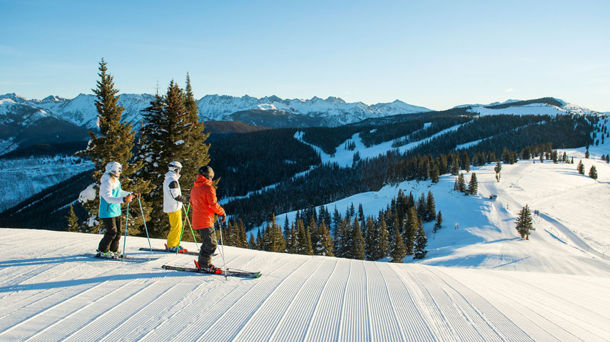 Friends preparing to ski groomed terrain in Vail, CO.