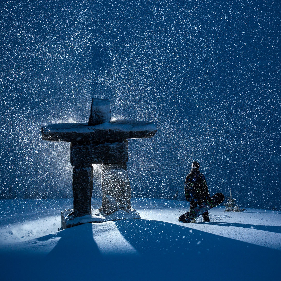 Inukshuk on Whistler Peak during a storm at night