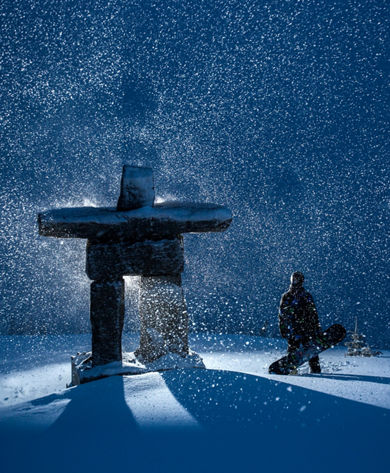 Inukshuk on Whistler Peak during a storm at night