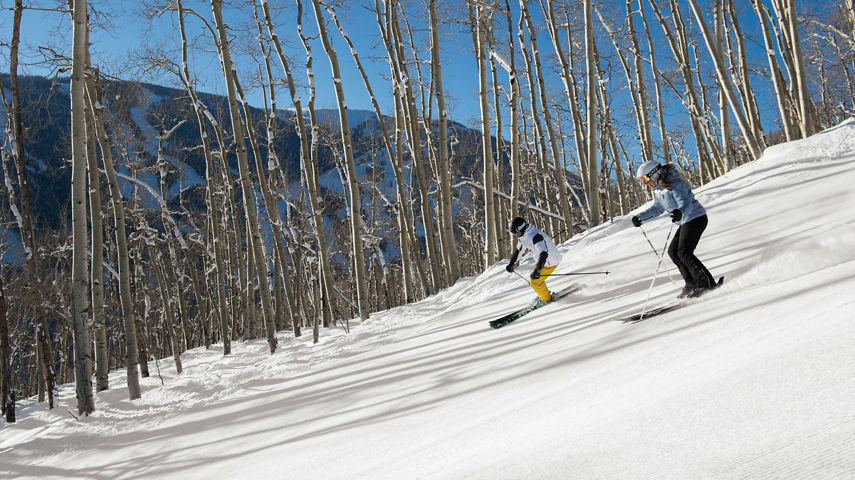 Couple Skis Groomed Runs at First Tracks in Beaver Creek, CO.