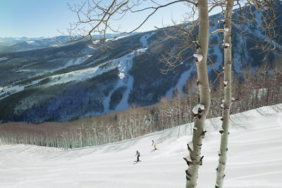 Couple Skis Groomed Runs at First Tracks in Beaver Creek, CO.
