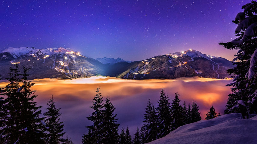Whistler And Blackcomb over the clouds at night