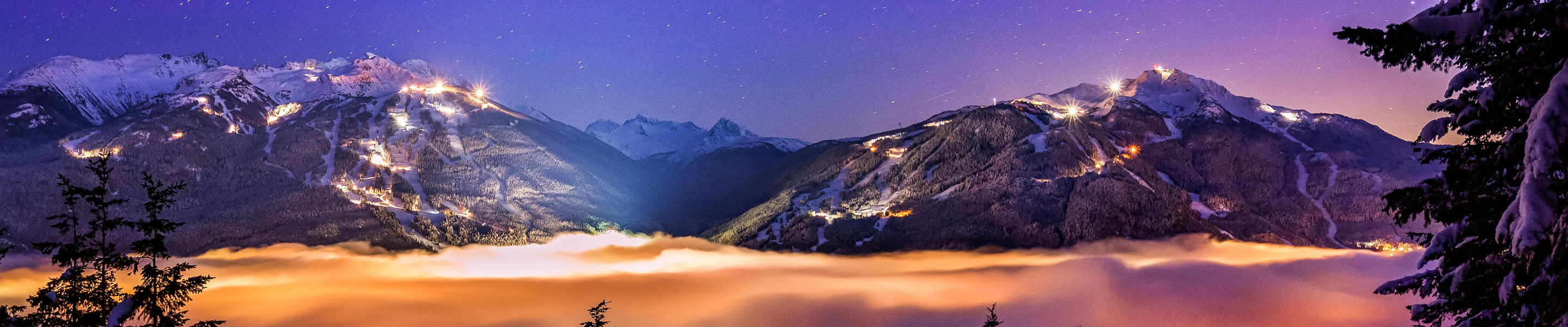 Whistler And Blackcomb over the clouds at night