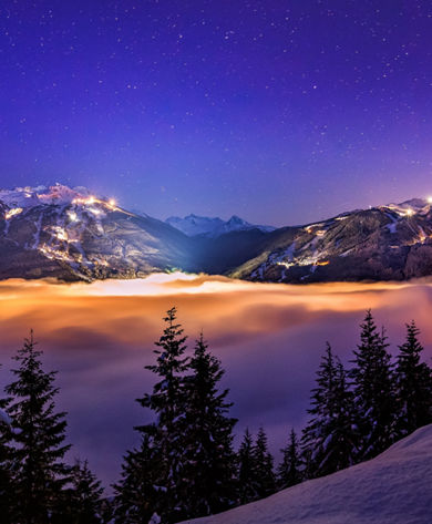 Whistler And Blackcomb over the clouds at night
