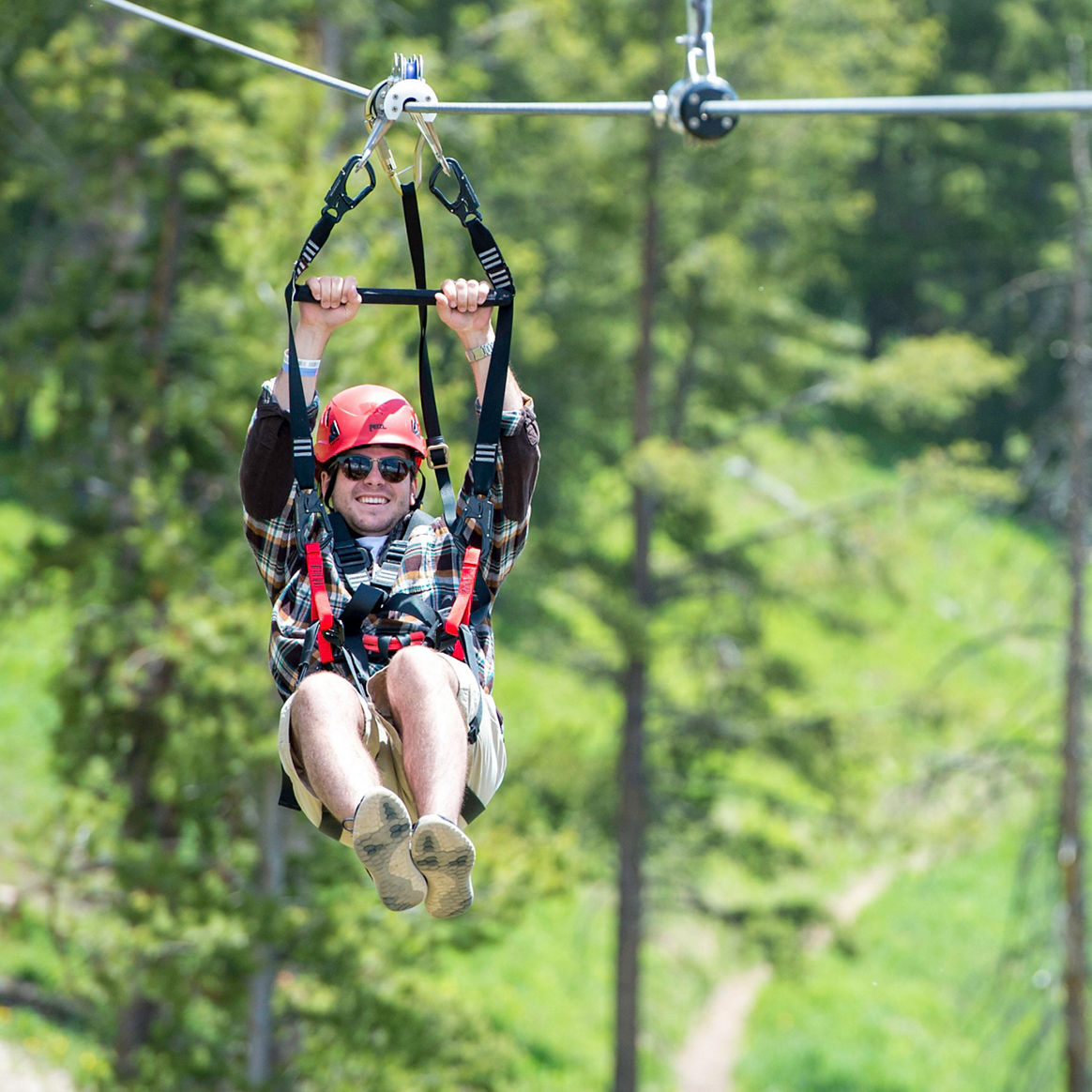 Ziplining outdoors over the mountain in Vail, CO.