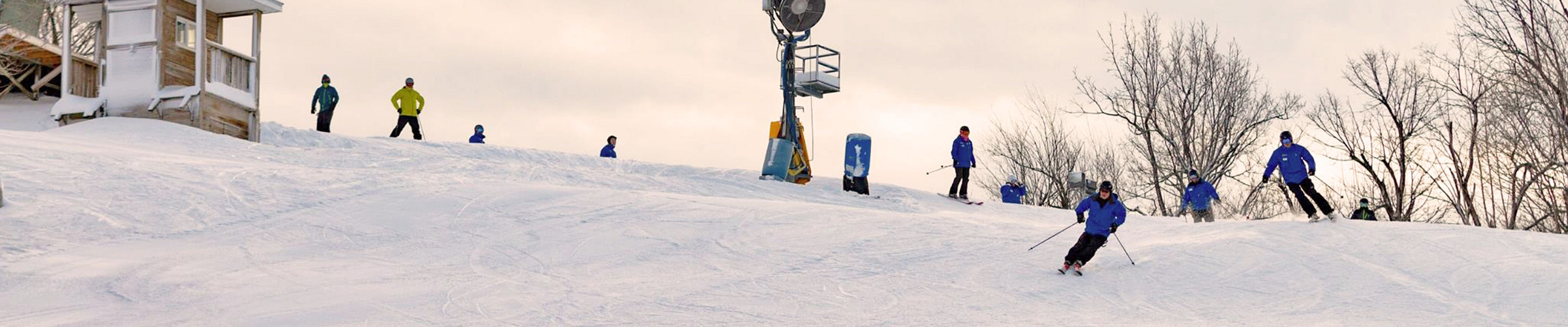 Skiers Make Turns Downhill at Mar River Mountain