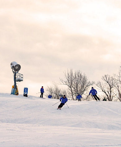 Skiers Make Turns Downhill at Mar River Mountain