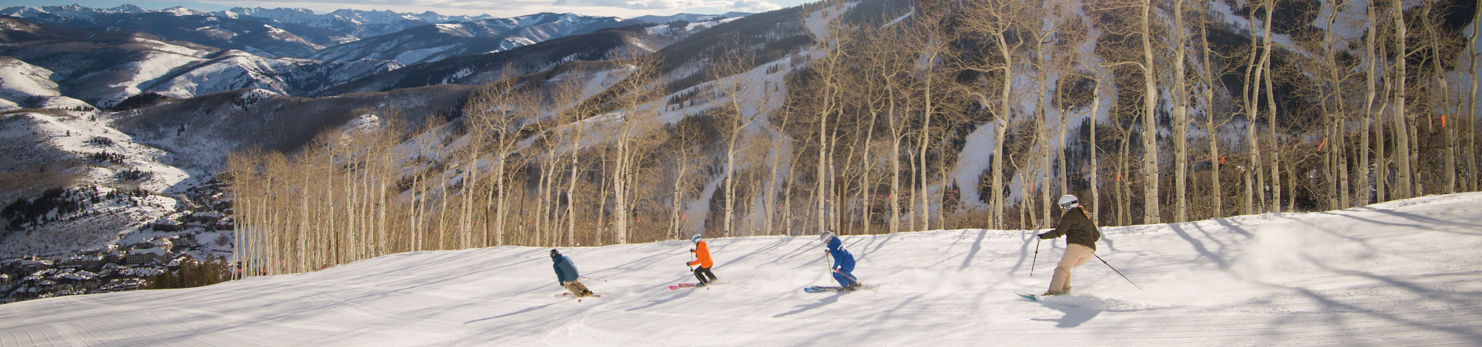 Group of friends ski with a private mountain Mountain Host at Beaver Creek, CO.