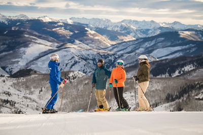 Group of friends ski with a private mountain Mountain Host at Beaver Creek, CO.