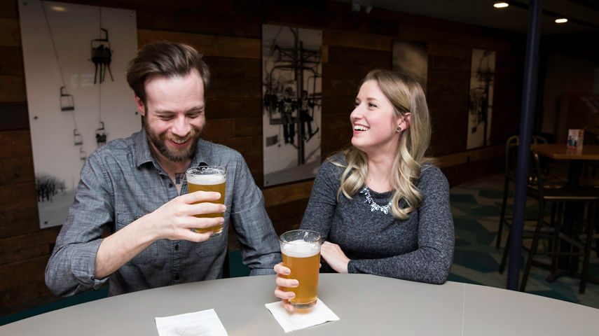 Couple enjoys a beverage at Ski Hill Grill Bar in Wilmot Mountain