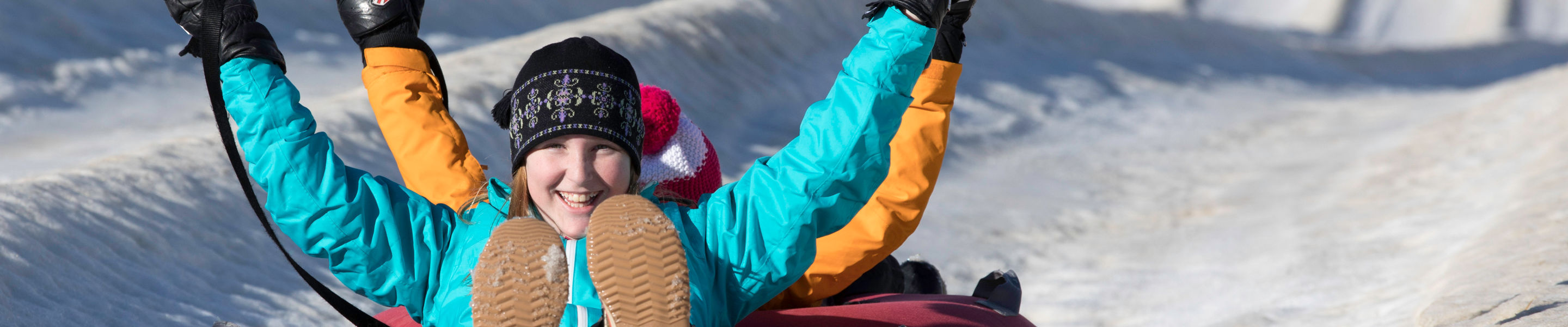 Family and friends enjoy the tubing hill at Wilmot Mountain