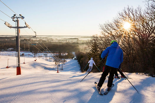 Family skis at sunrise in Wilmot Mountain