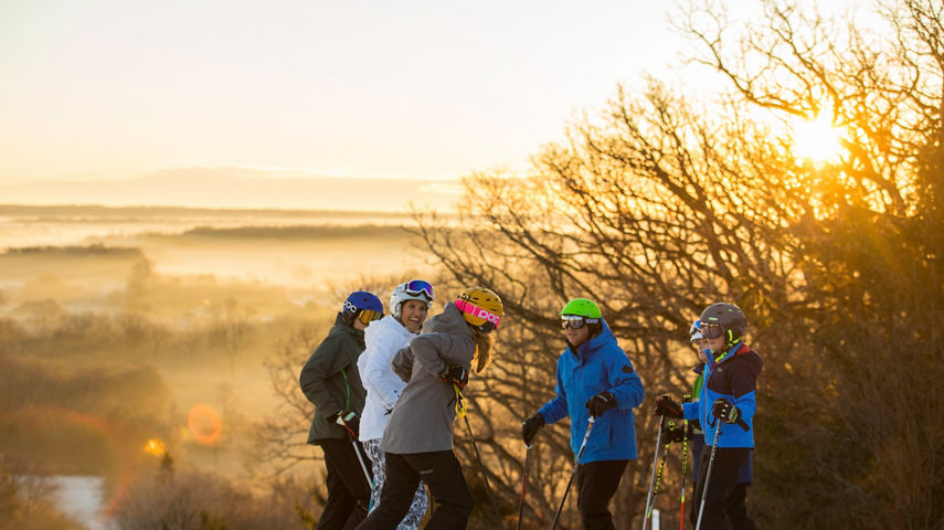 Family skis at sunrise in Wilmot Mountain