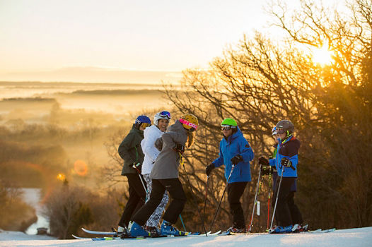Family skis at sunrise in Wilmot Mountain