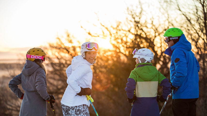 Family skis at sunrise in Wilmot Mountain