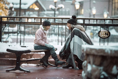 A Grandmother helps her granddaughter lace ice skates at Beaver Creek, CO.