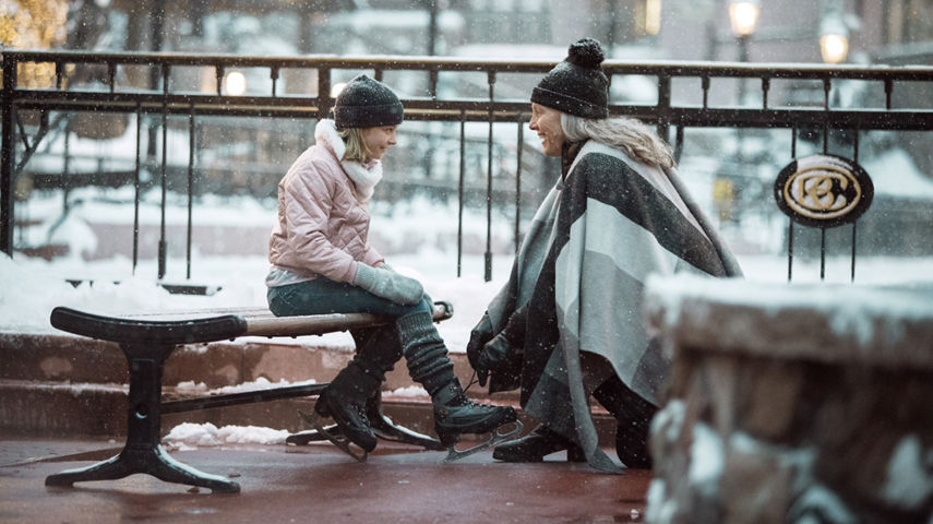 A Grandmother helps her granddaughter lace ice skates at Beaver Creek, CO.