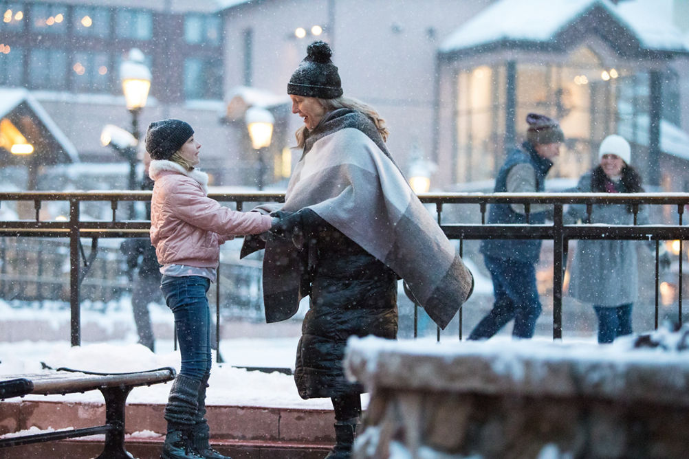 A Grandmother helps her granddaughter lace ice skates at Beaver Creek, CO.