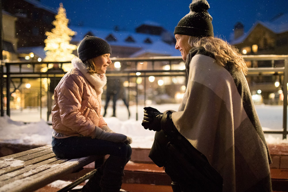 A Grandmother helps her granddaughter lace ice skates at Beaver Creek, CO.