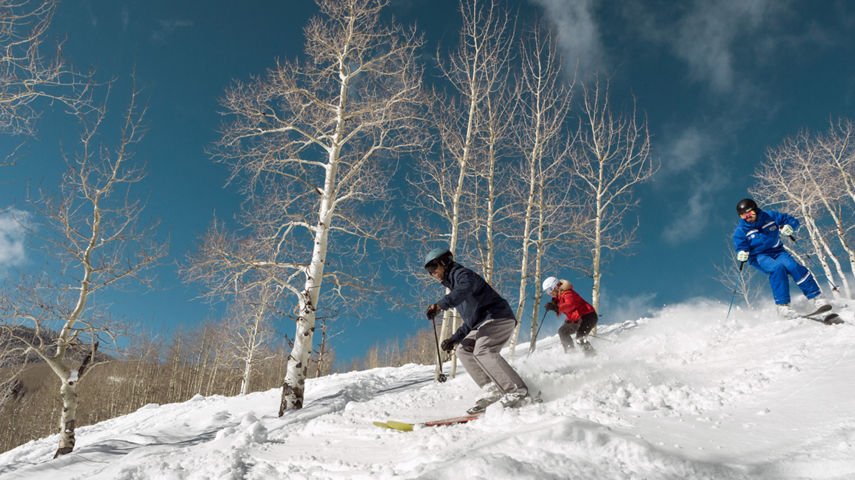 Private mountain Mountain Host escorts a couple through Thresher Glade in Beaver Creek, CO.