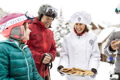 Family receives hot cookies after skiing in Beaver Creek, CO.