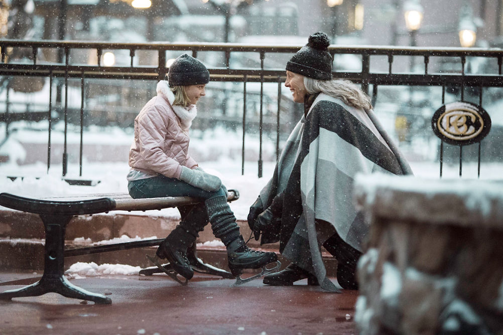 Mother and daughter prepare to ice skate in the village at Beaver Creek, CO.