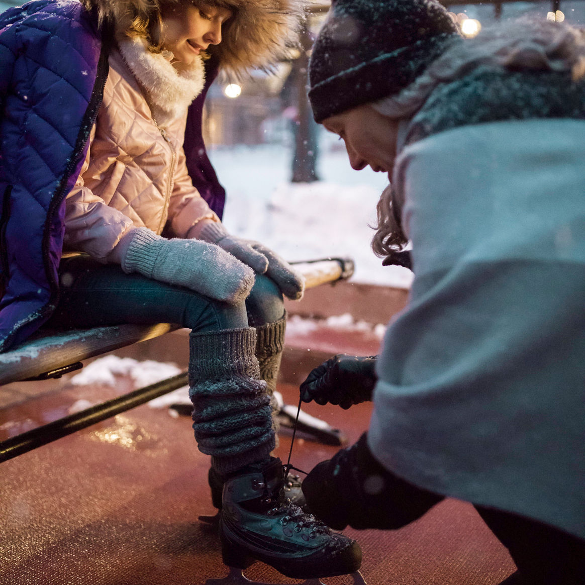 Mother and daughter prepare to ice skate in the village at Beaver Creek, CO.