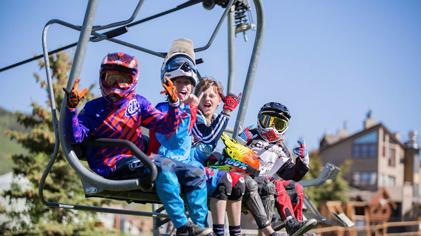 Kids in bike gear take chairlift in Crested Butte, CO.