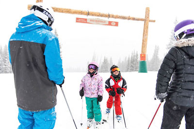 Family skiing on a powder day in Beaver Creek, CO.