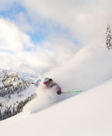 Woman Skiing Powder at Aquarius Face at Stevens Pass