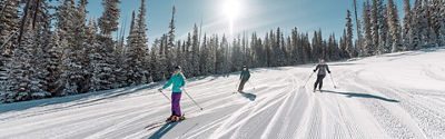Family skis in Red Buffalo Park adventure zone in Beaver Creek, CO.