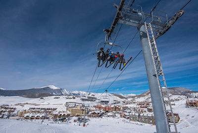 Skiers on the chairlift in Crested Butte, CO.