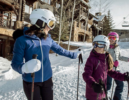 Family enjoys ski-in, ski-out lodging on a bluebird day in Beaver Creek, CO.