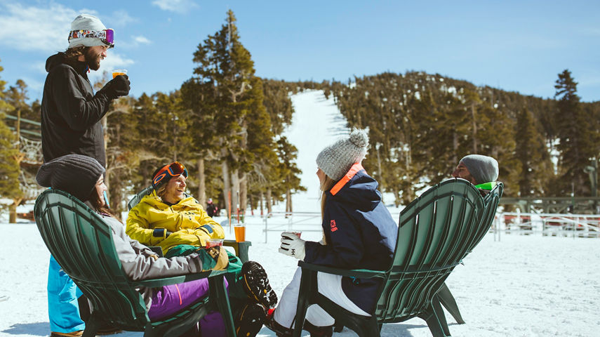 Friends relax on mountain after skiing in Heavenly, CA.