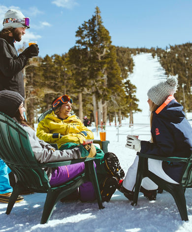 Friends relax on mountain after skiing in Heavenly, CA.